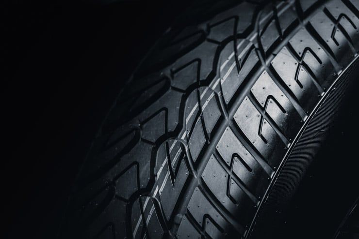 A Close Up of a Tire on a Black Background — Mick’s Towing Service Pty Ltd in Carrara, QLD
