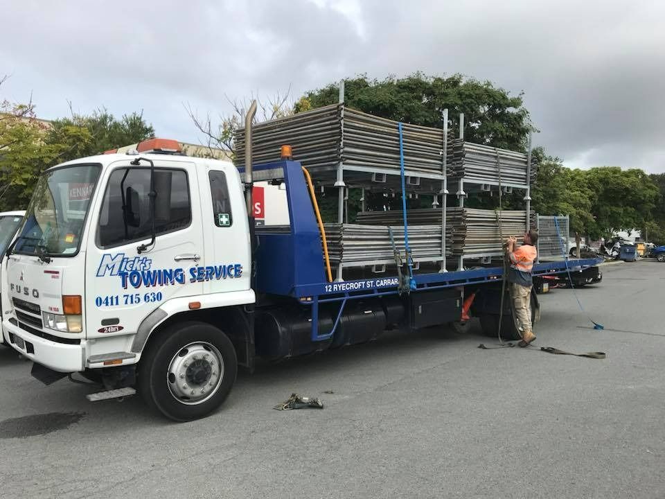 A Blue and White Towing Truck is Parked in a Parking Lot — Mick's Towing Service Pty Ltd in Carrara, QLD