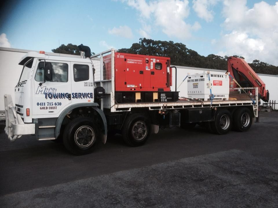 A Towing Service Truck is Parked in a Parking Lot — Mick's Towing Service Pty Ltd in Carrara, QLD