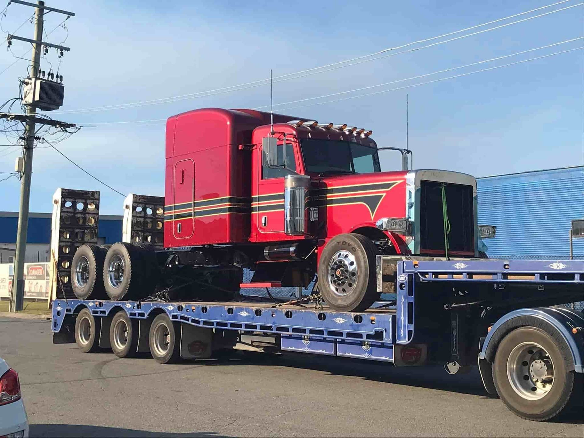 A Red Semi Truck is Sitting on Top of a Blue Trailer — Mick's Towing Service Pty Ltd in Carrara, QLD