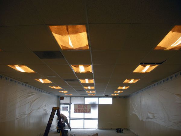 hand of worker using gypsum plaster ceiling joints at construction site