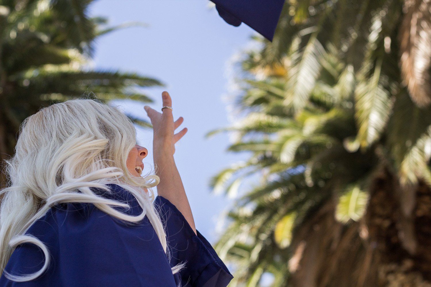 throwing graduation cap in air