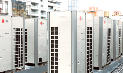 Row of LG-branded Multi V 5 HVAC units on a building rooftop, with a city backdrop.