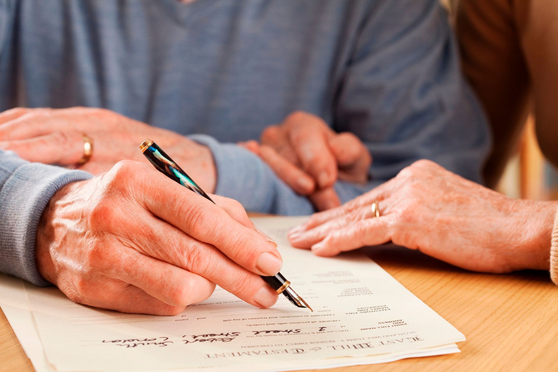 Man reviewing and signing legal papers during retirement planning to secure his future and legacy.