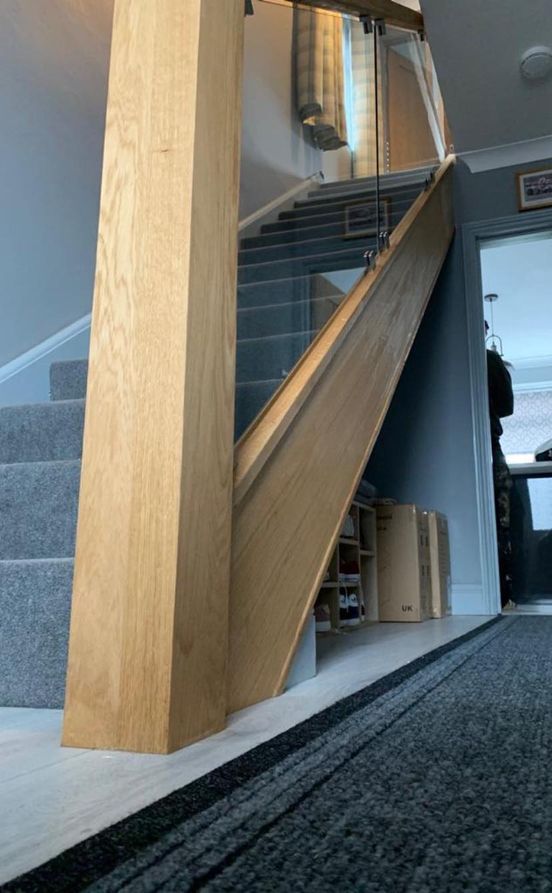 wooden stairs with grey carpet