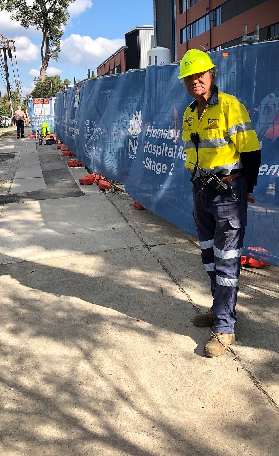 Man Standing at Construction Site — Ingleburn, NSW — Roads & Traffic Management Services