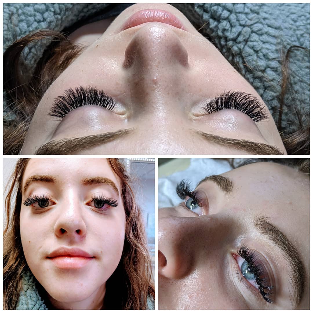 A close up of a woman 's face with long eyelashes