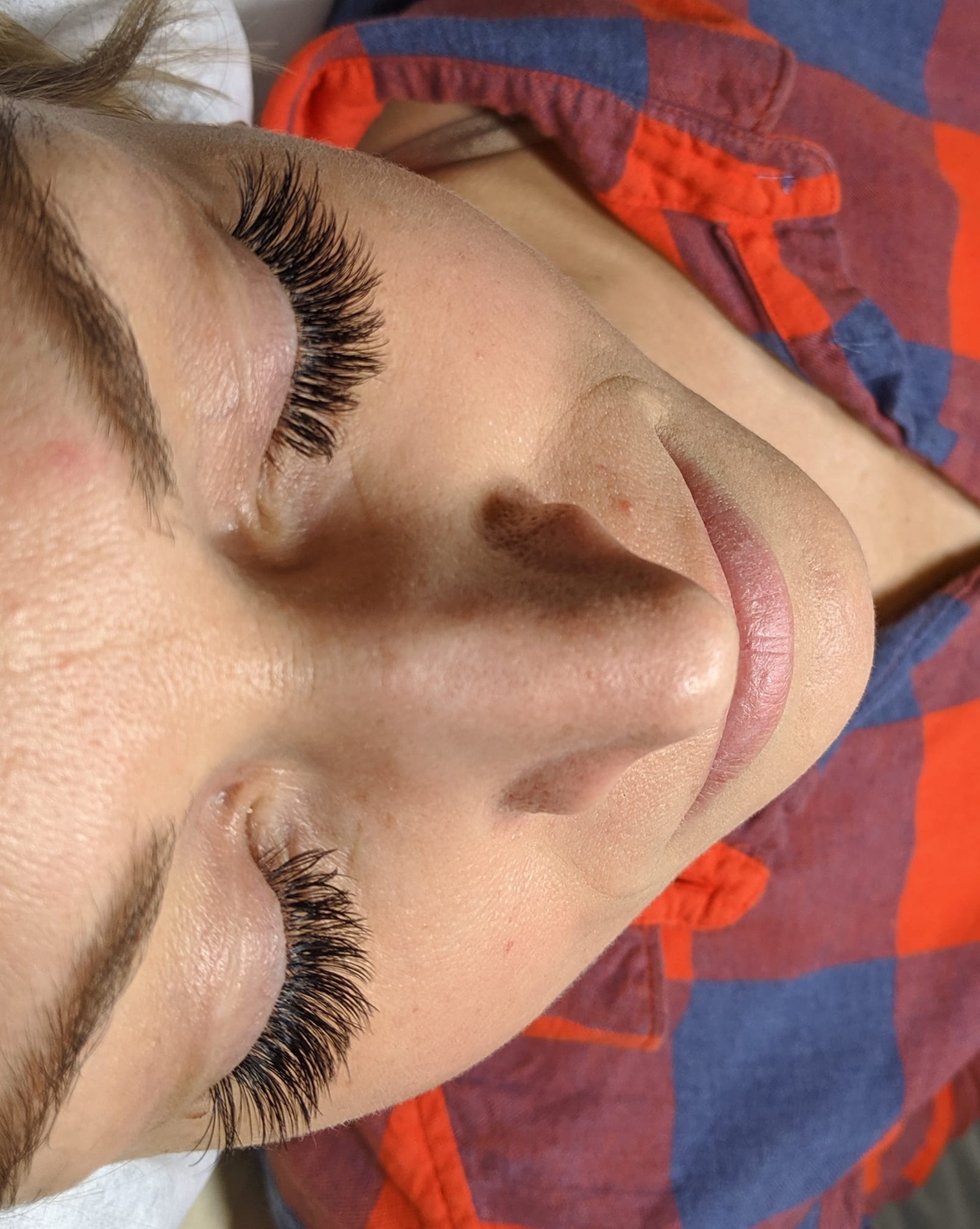 A close up of a woman 's face with long eyelashes