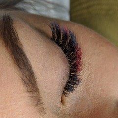 A close up of a woman 's eye with long eyelashes.