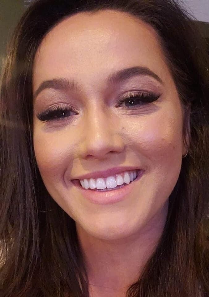 A close up of a woman 's face smiling.