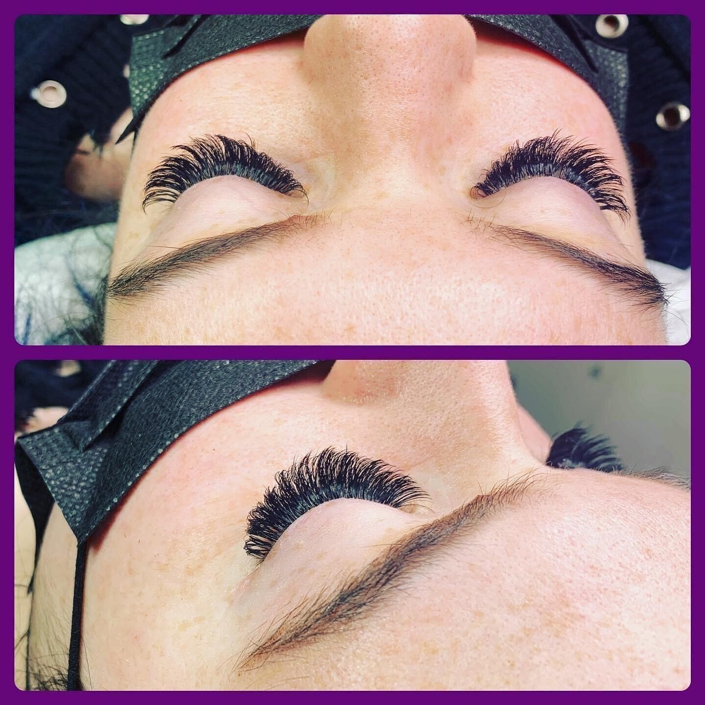 A close up of a woman 's eye with long eyelashes