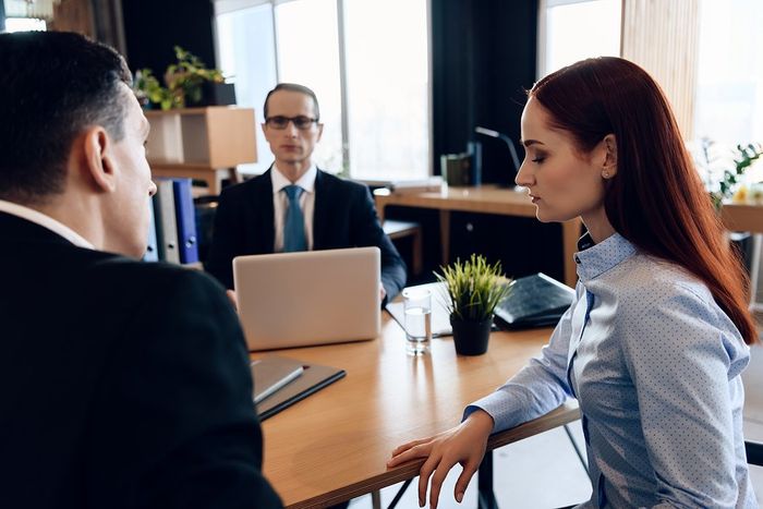three people sitting inside the office