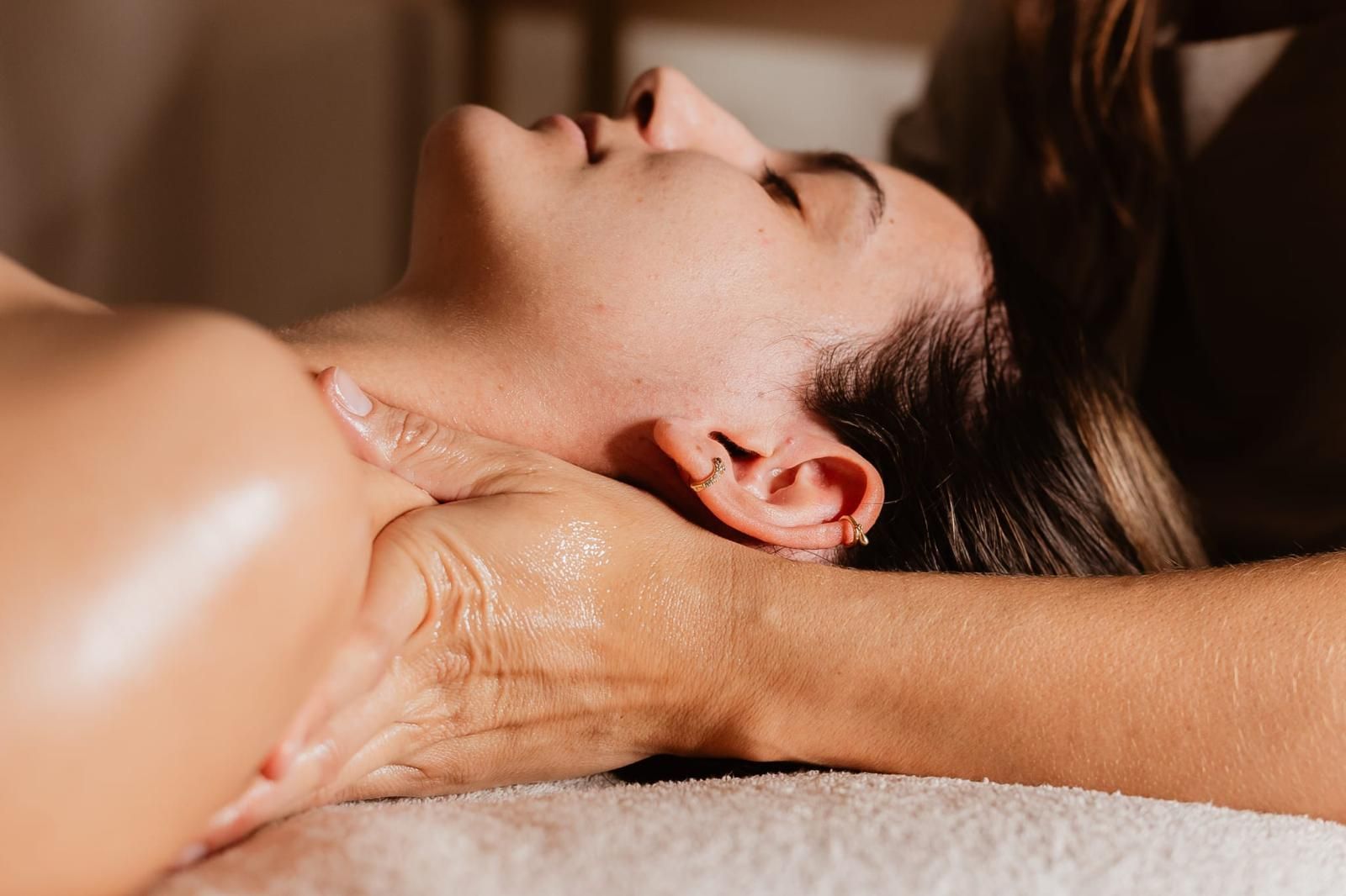 A woman is laying on a table getting a massage.