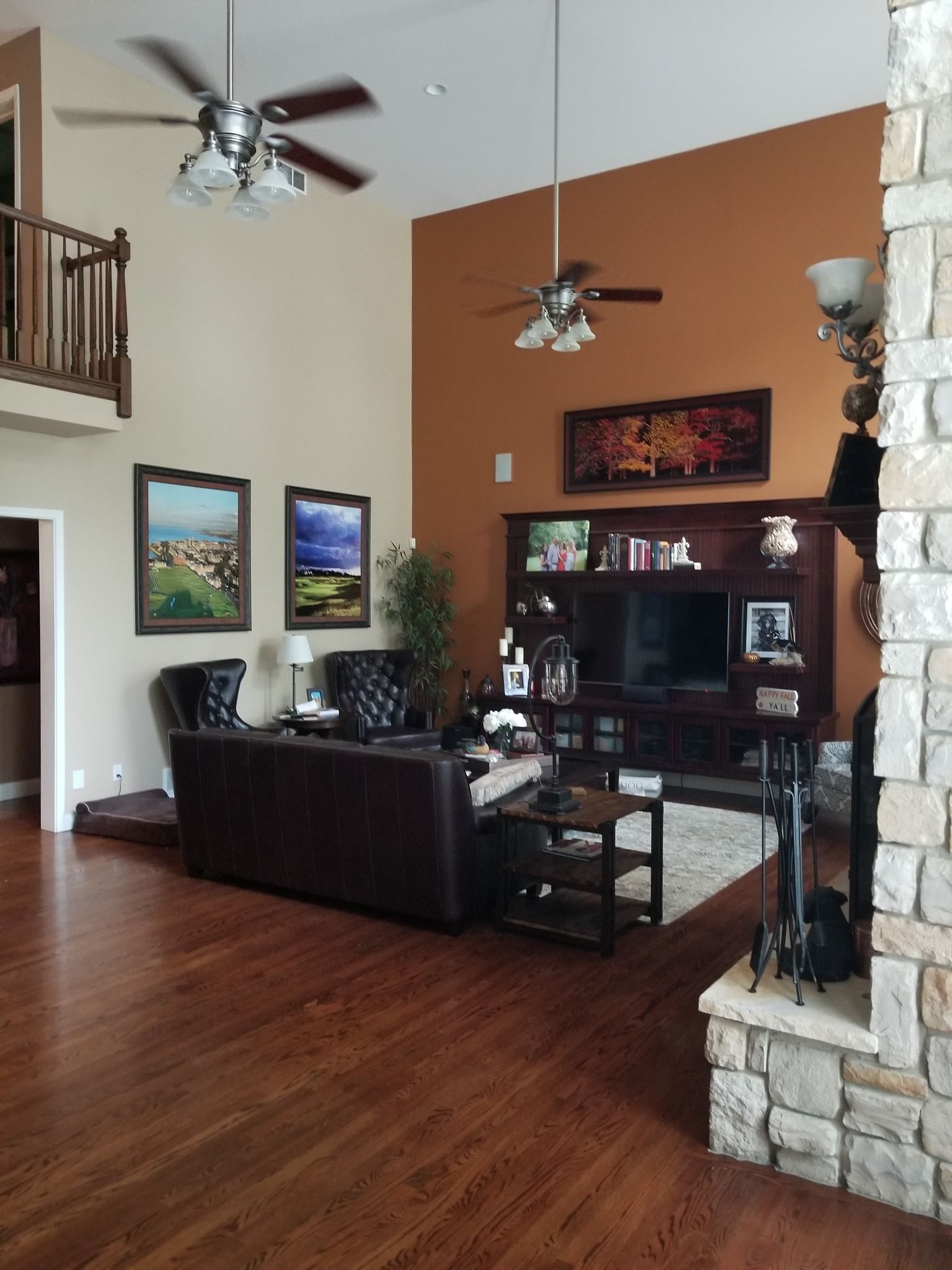 A living room with hardwood floors and a ceiling fan