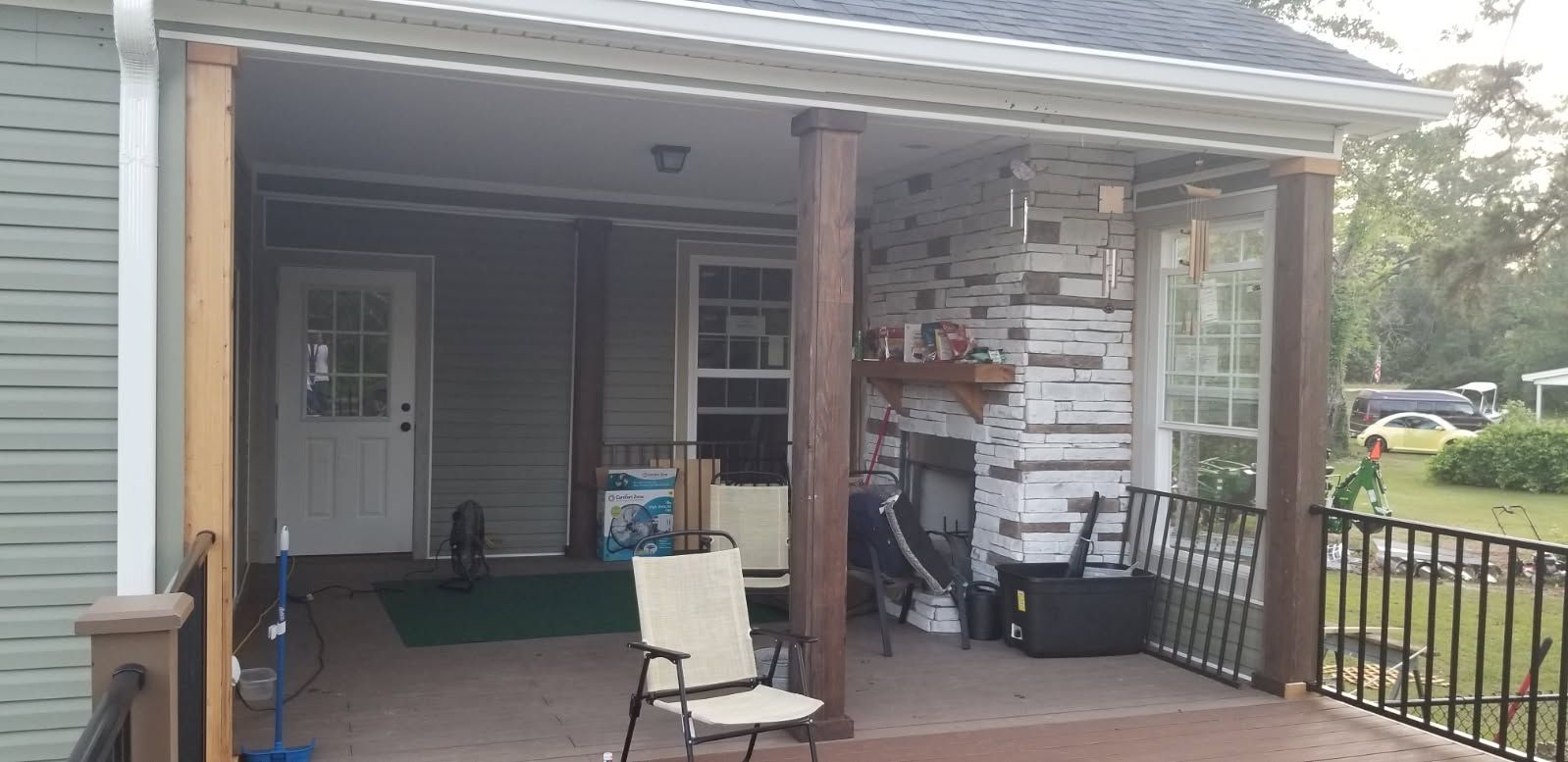 A porch with a chair and a cooler on it