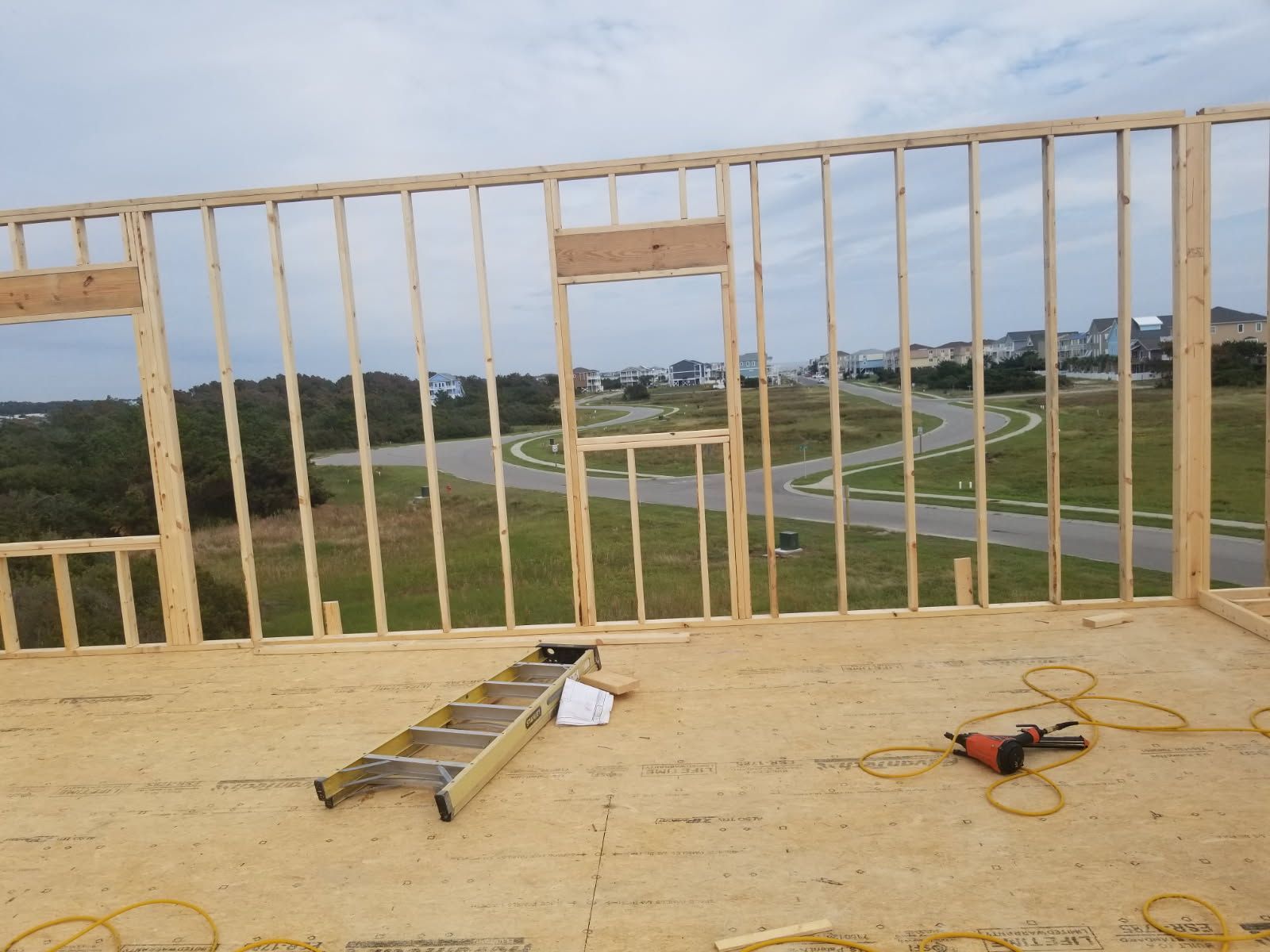 A ladder is on the floor of a building under construction