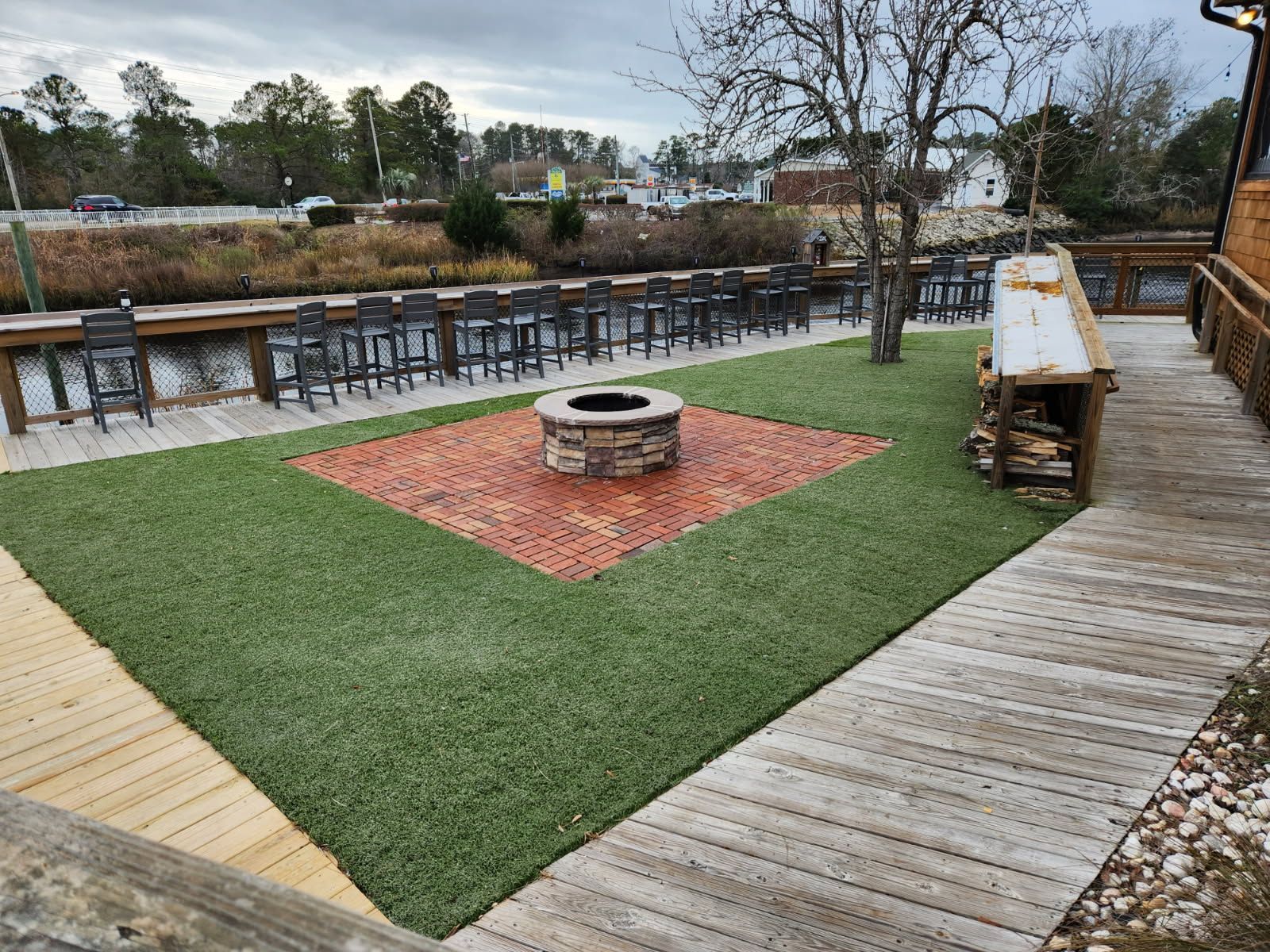 There is a fire pit in the middle of the grass.