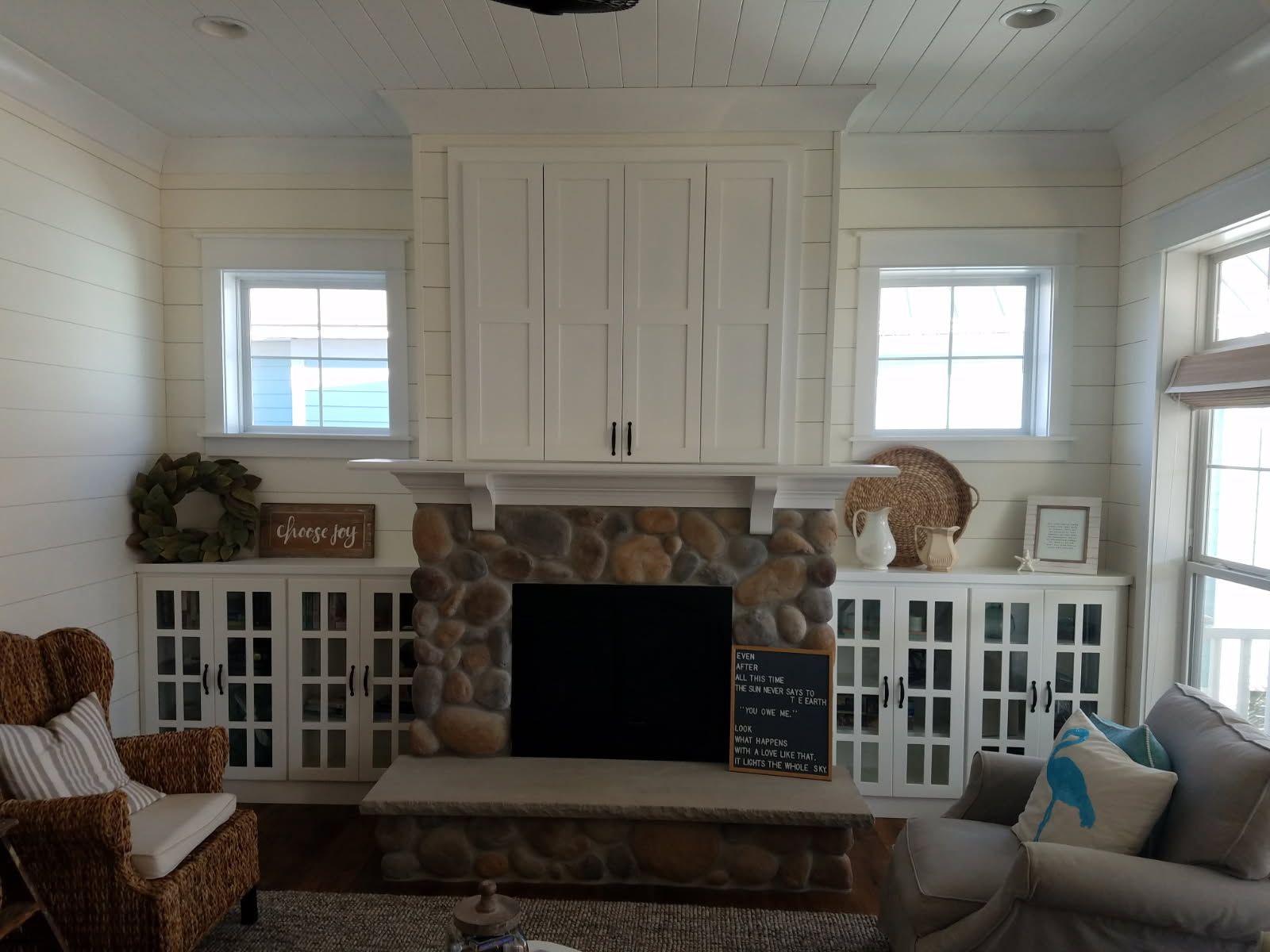 A living room with a fireplace and a sign that says 