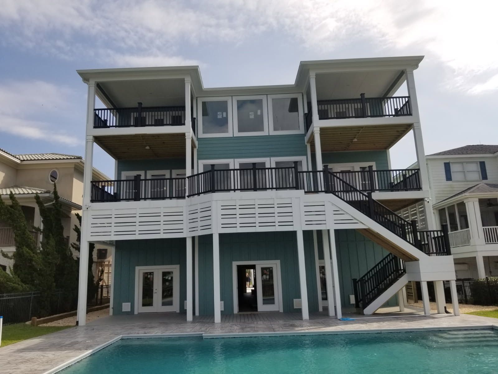 A large house with a swimming pool in front of it