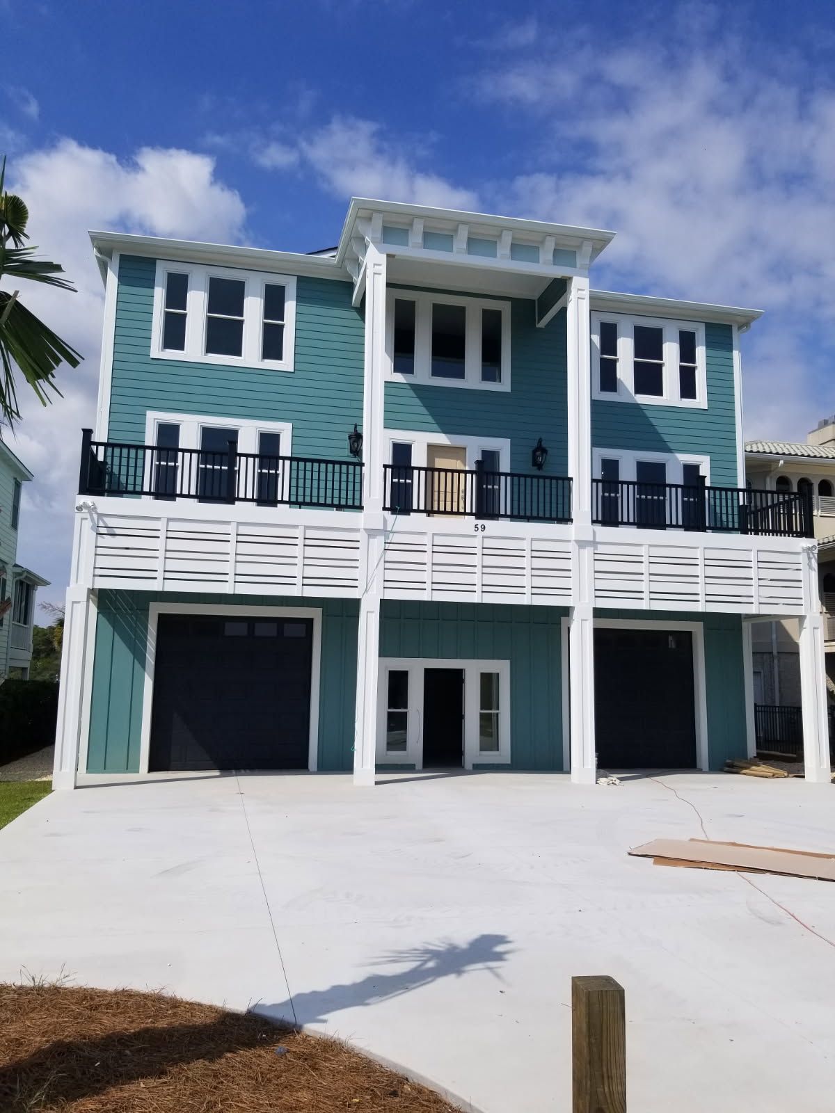 A large blue and white house with a lot of windows