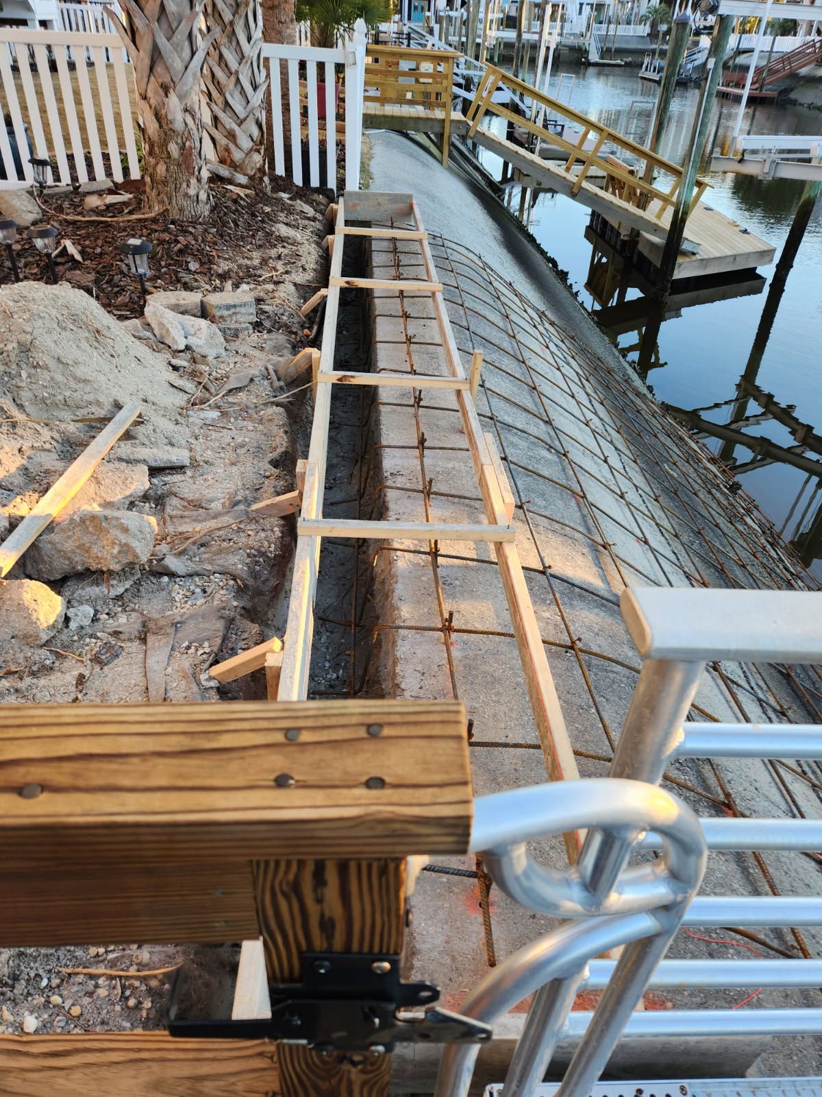 A wooden bench is being built next to a dock.