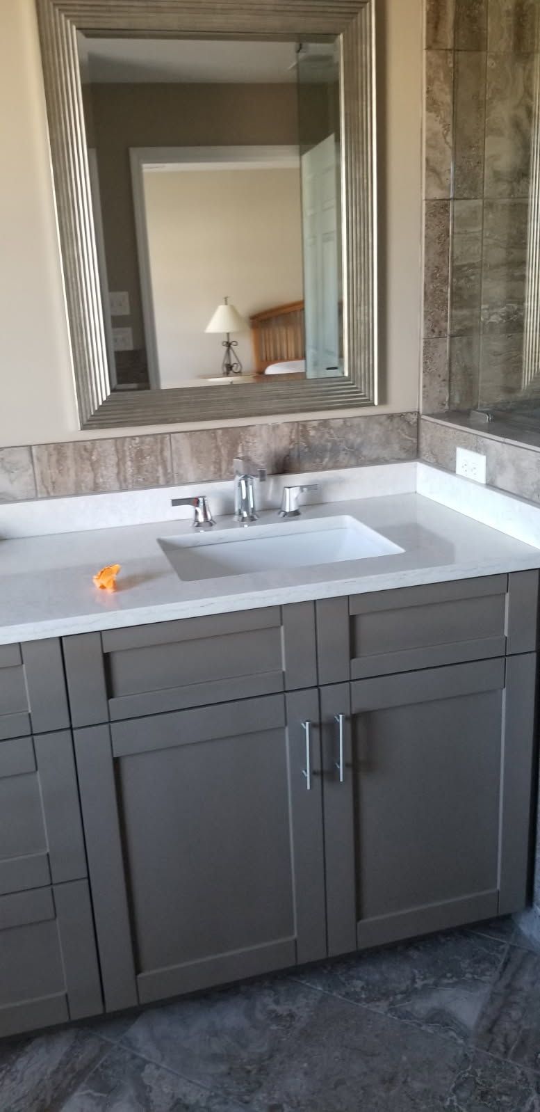 A bathroom vanity with a sink and a mirror.