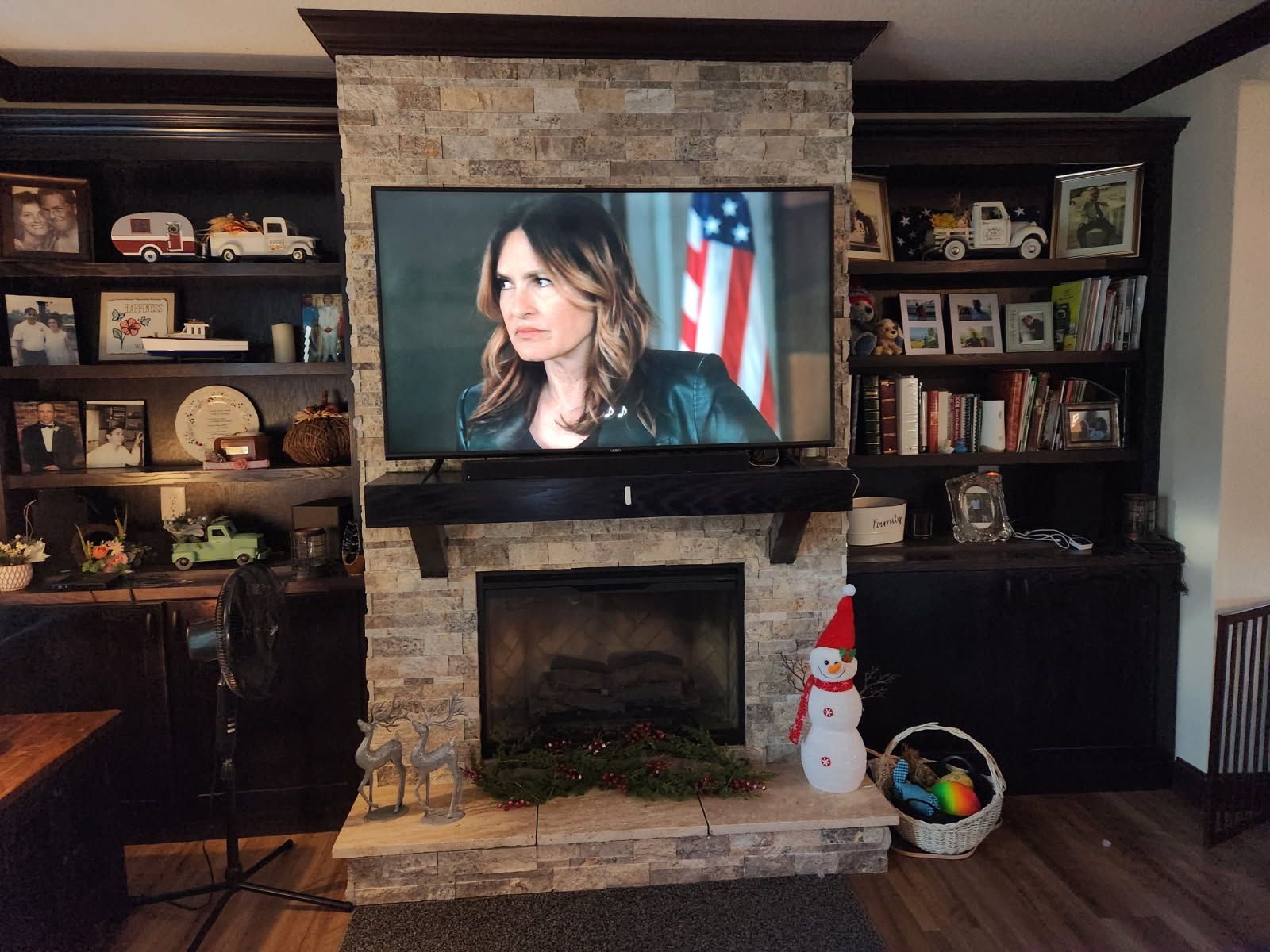 A living room with a fireplace and a flat screen tv.