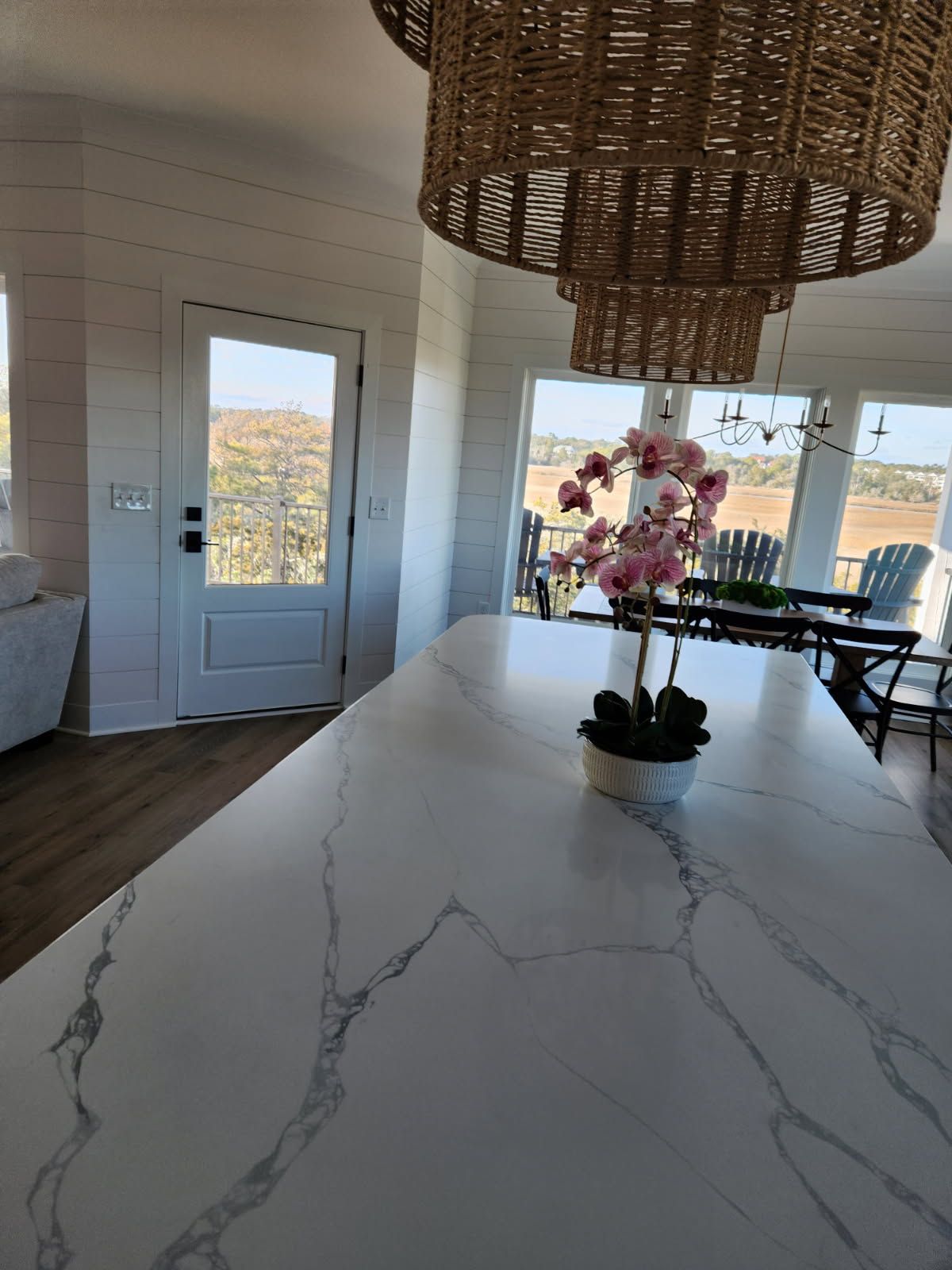 A white counter top with a potted plant on it in a kitchen.