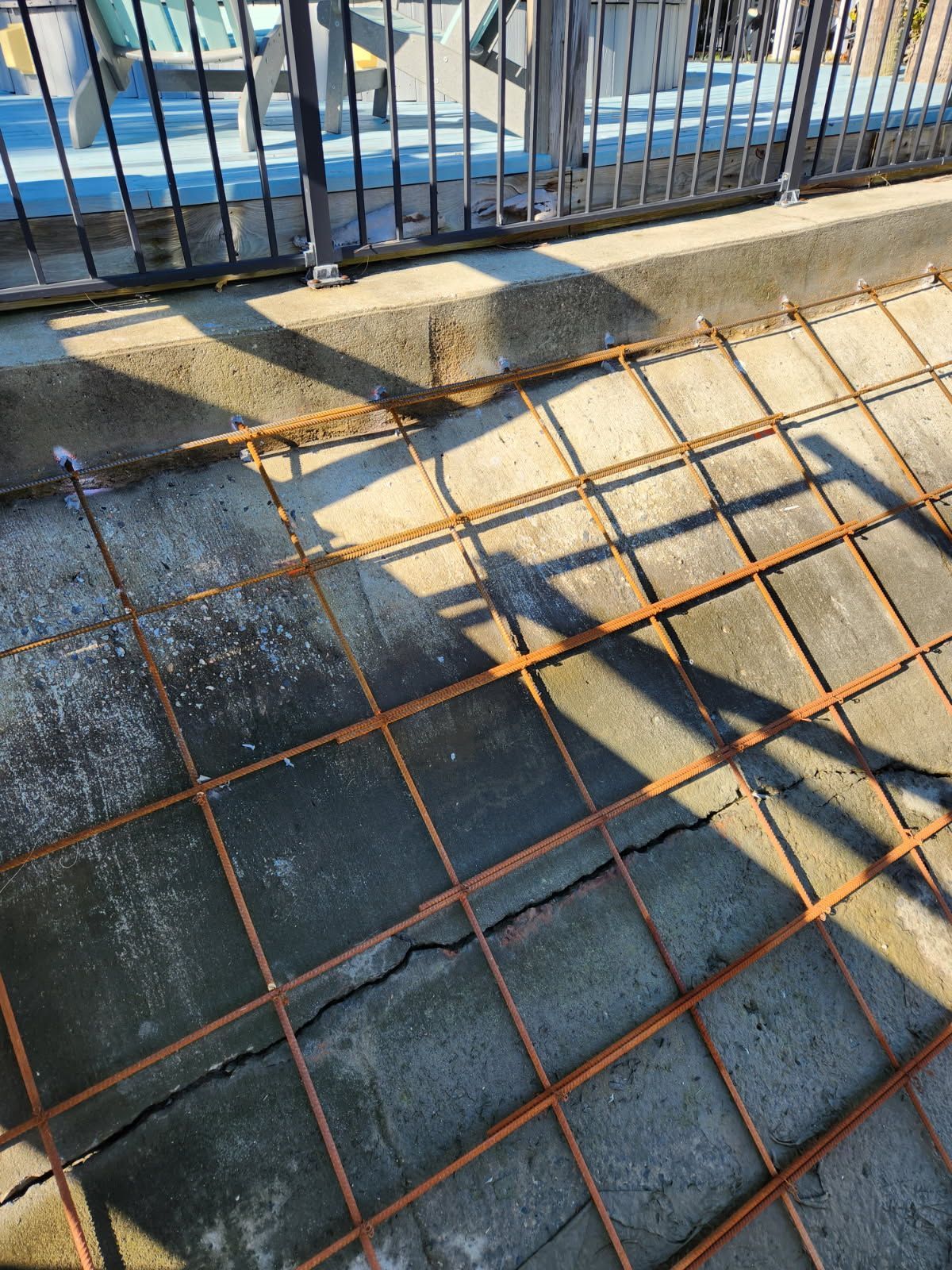 A shadow of a person is cast on a concrete surface