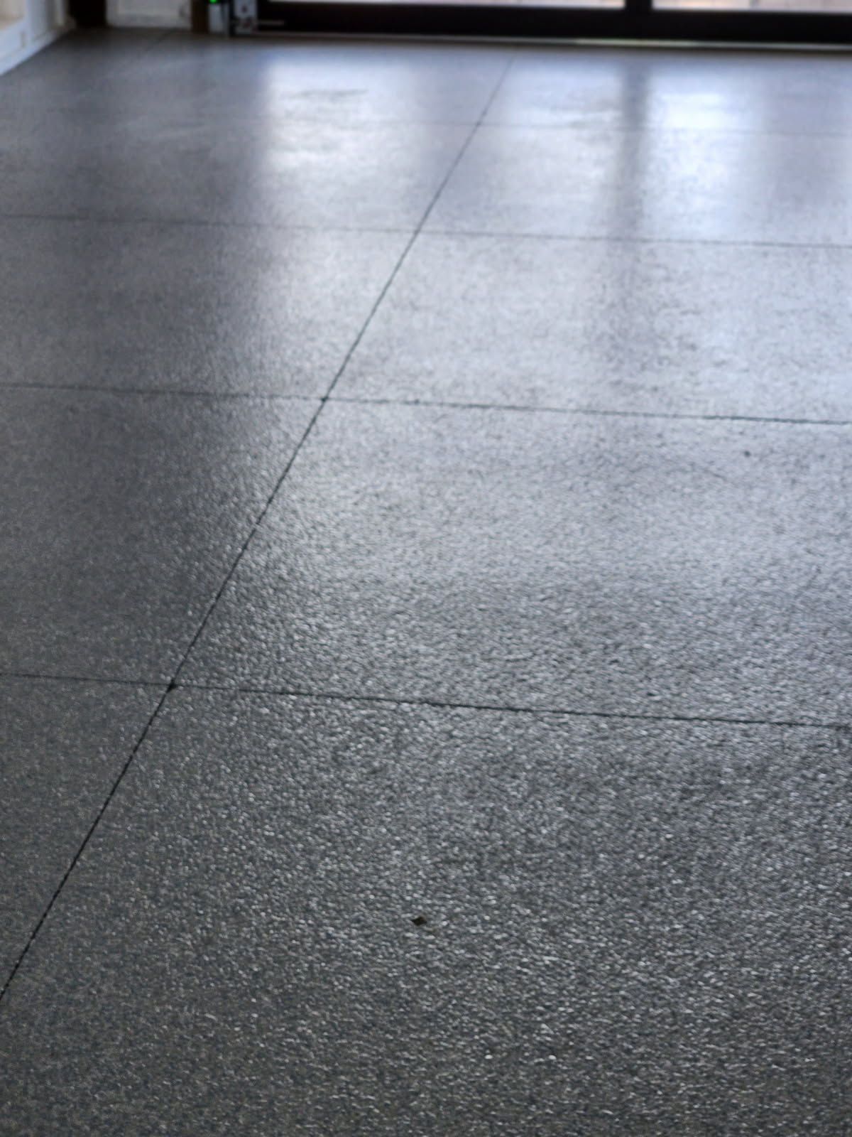 A close up of a gray tiled floor in a room.