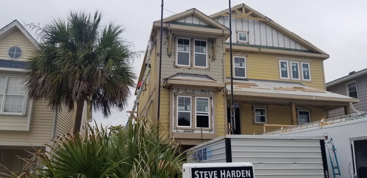 A house under construction with a sign that says `` steve harden '' in front of it.