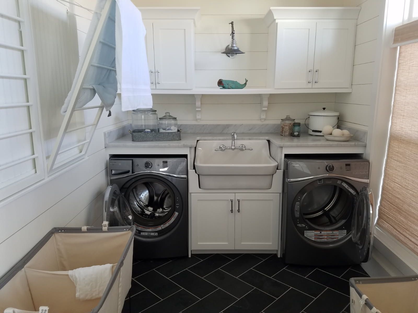 A laundry room with a washer and dryer and a sink