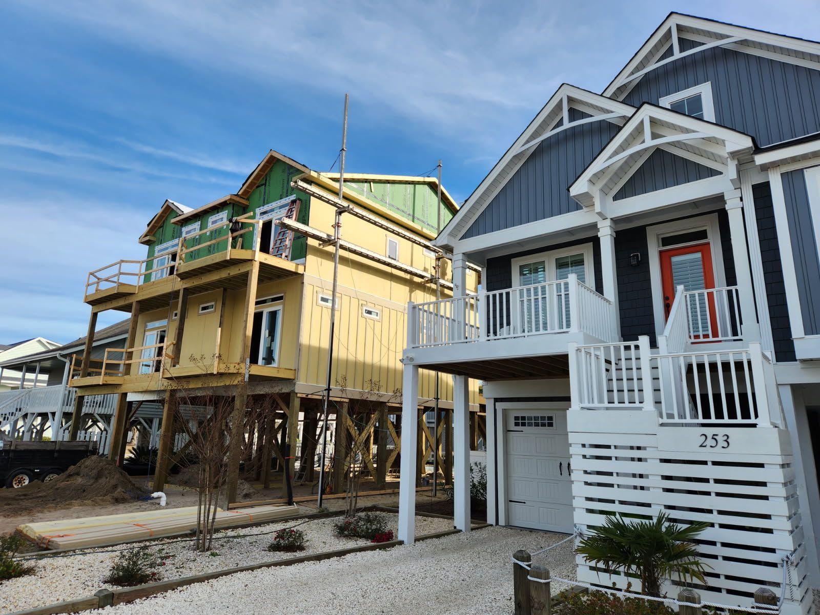 A row of houses under construction in a residential area.