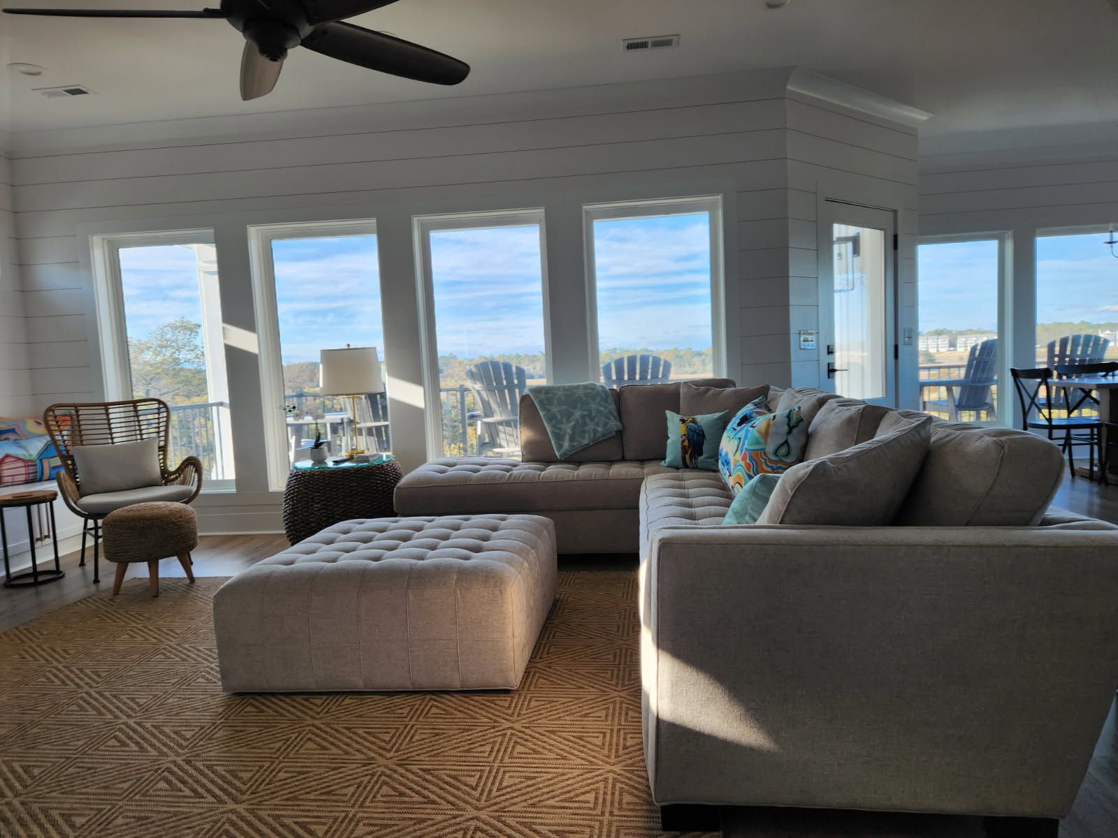A living room filled with furniture and a ceiling fan.