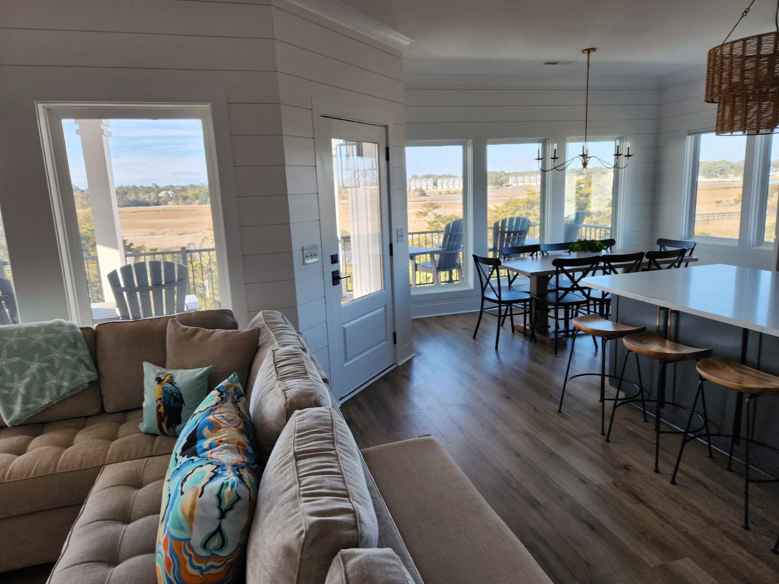 A living room with a couch , table , chairs and stools.