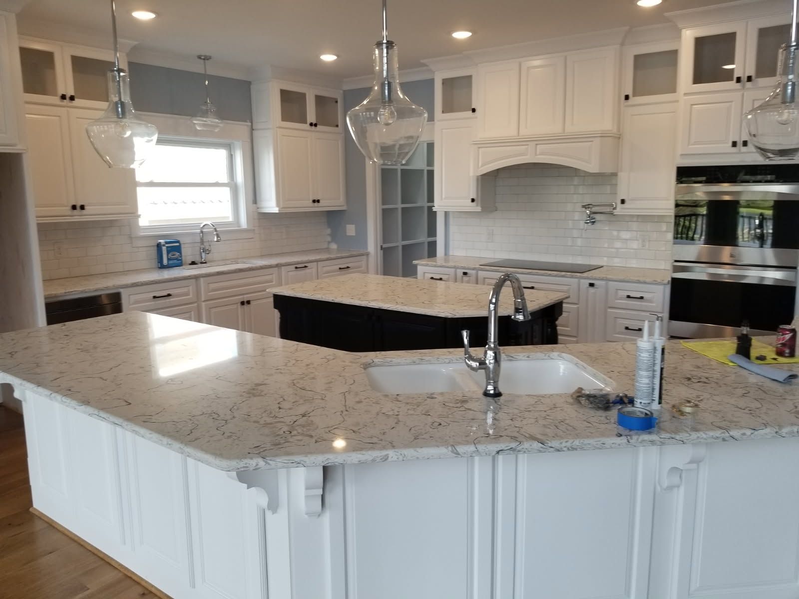 A kitchen with white cabinets and granite counter tops