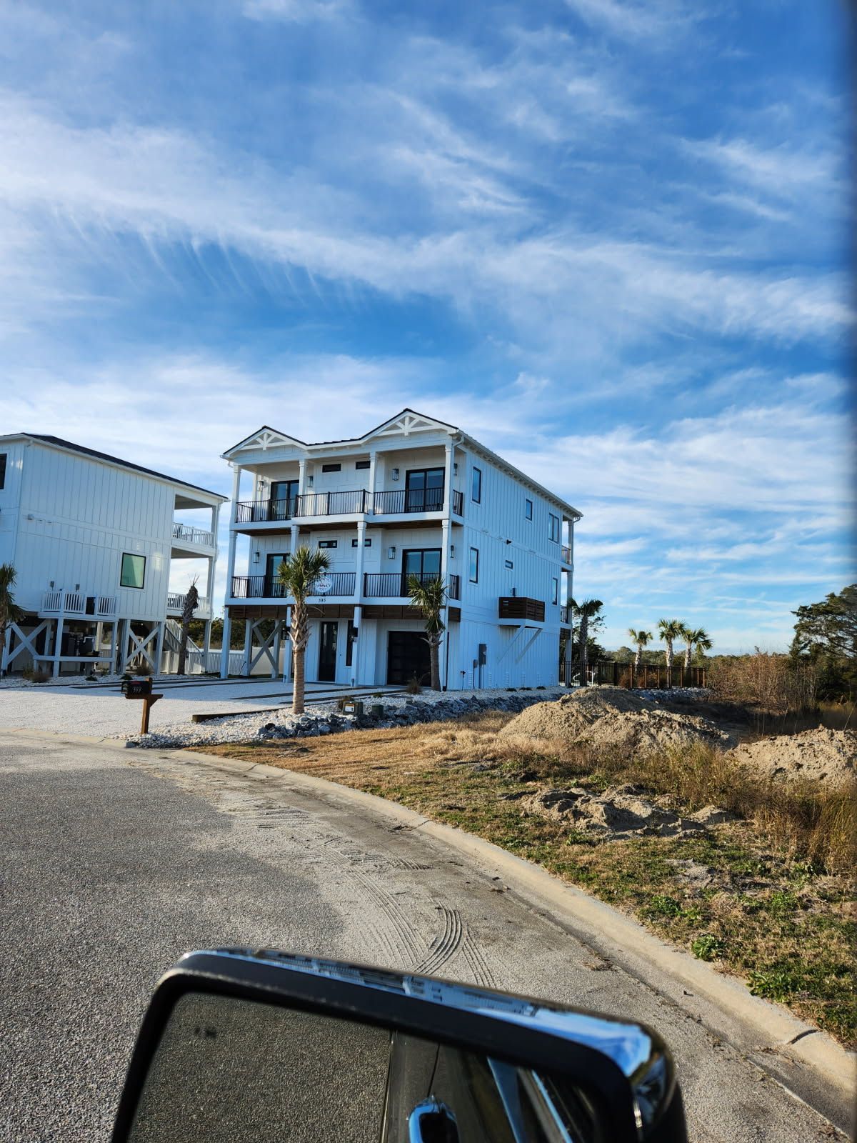 A view of a house from a car 's rear view mirror