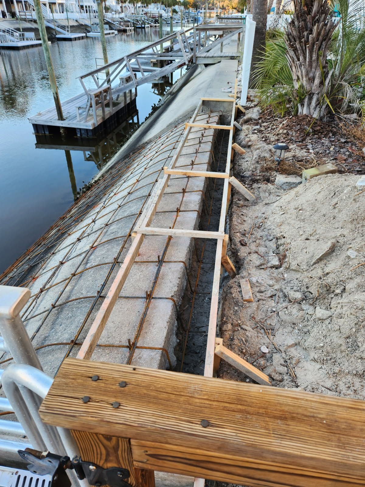 A wooden bench is being built next to a body of water.