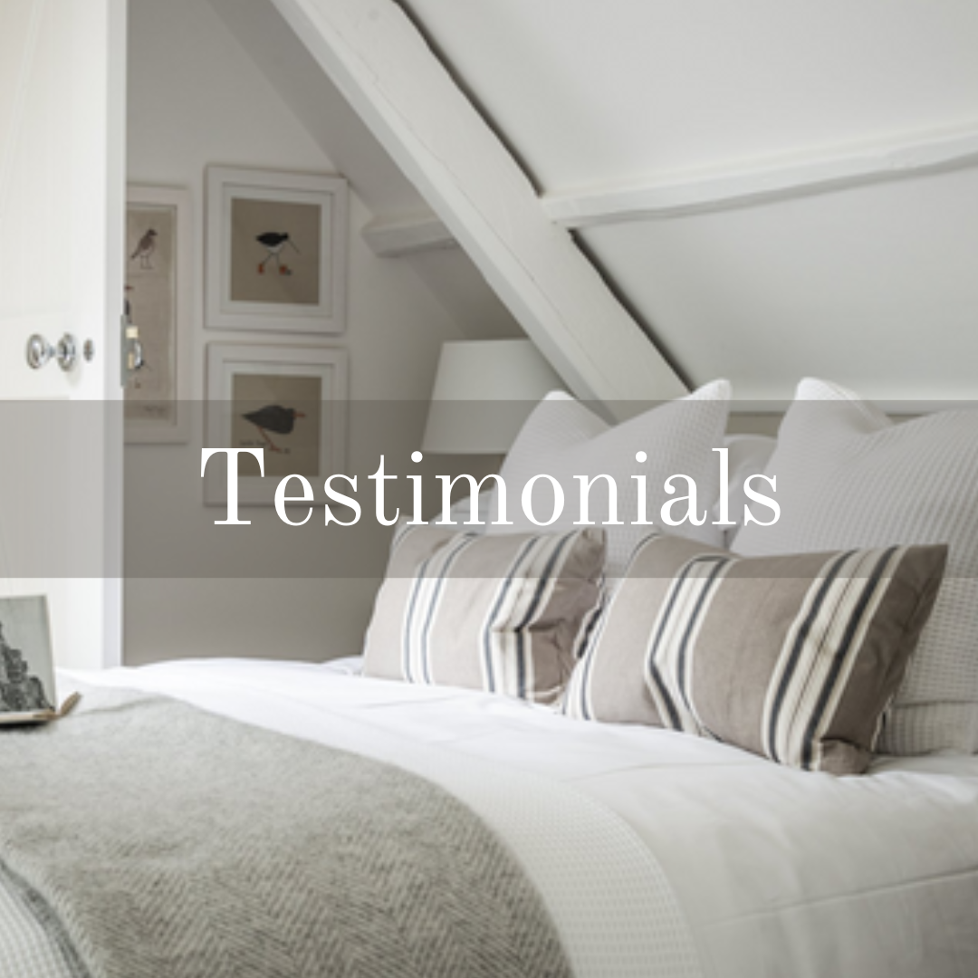 Testimonials for Cotswold Tiger Laundry, bed with white bedding and neutral cushions and throw