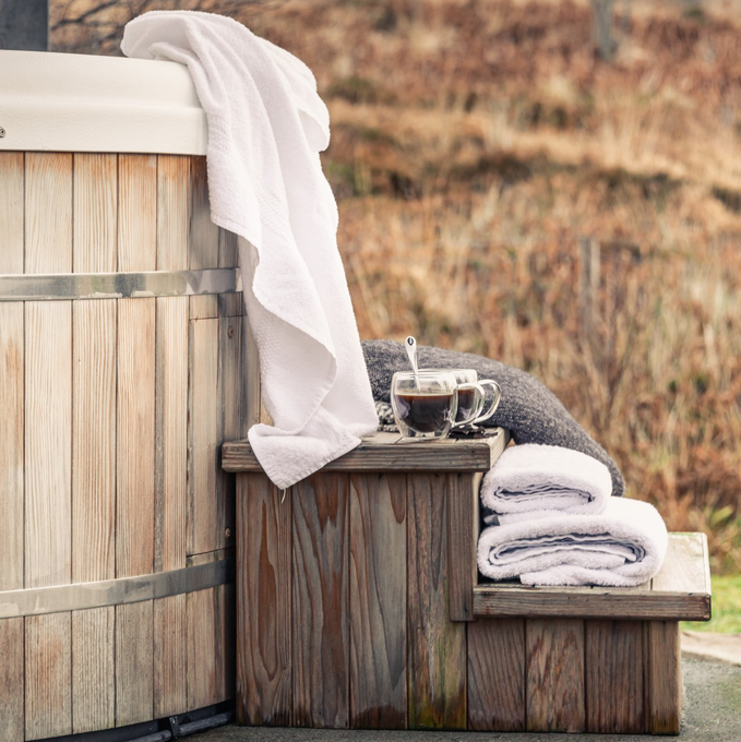 Freshly washed white towels on step to hot tub at a holiday cottage in the Cotswolds | Cotswold Tiger Laundry