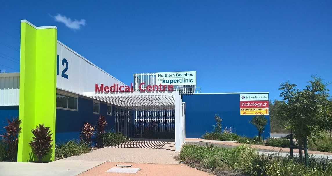 A Blue and White Building With the Number 12 on It — Northern Beaches GP Superclinic in Deeragun, QLD