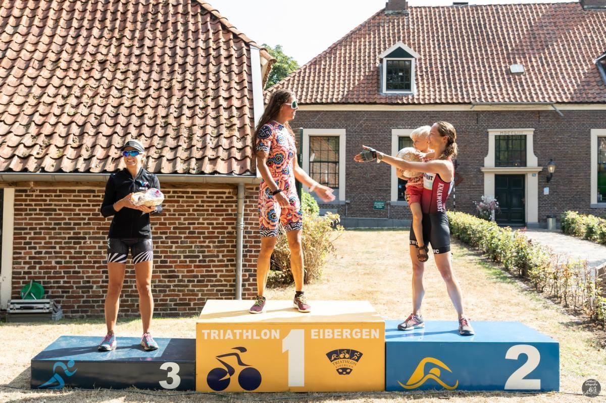 Een groep mensen die op een podium staan ​​met het cijfer 2 erop.