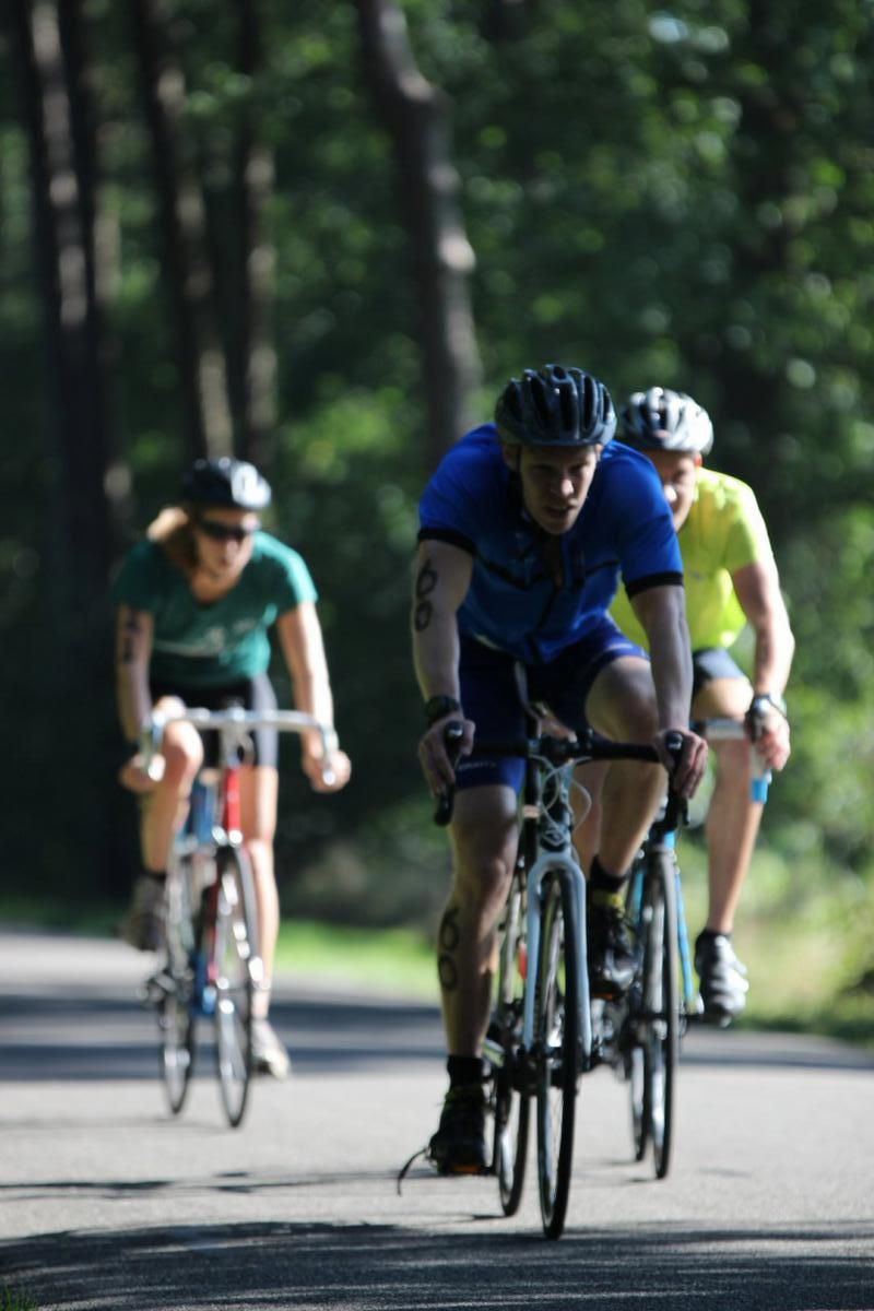 Een groep mensen fietst over een weg