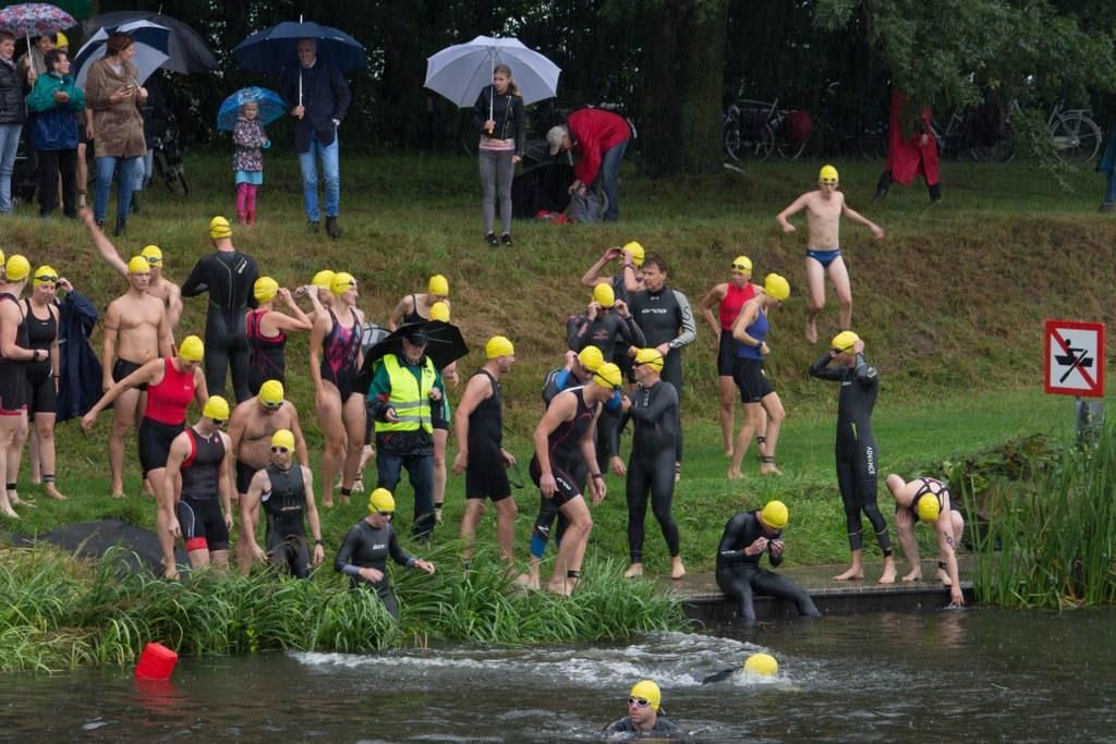 Een groep mensen maakt zich klaar om in een rivier te gaan zwemmen.