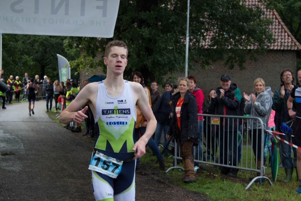 Een jongeman doet mee aan een race met nummer 157 op zijn shirt.