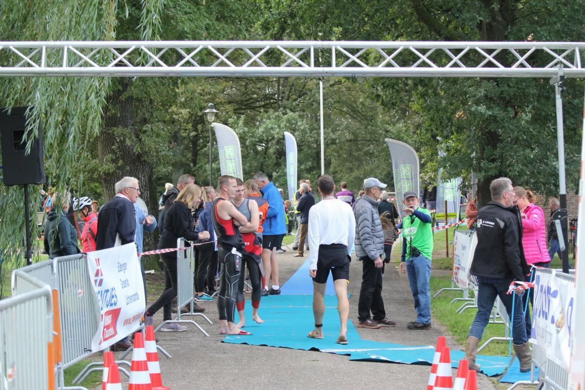 Een groep mensen staat rond een blauwe loper.