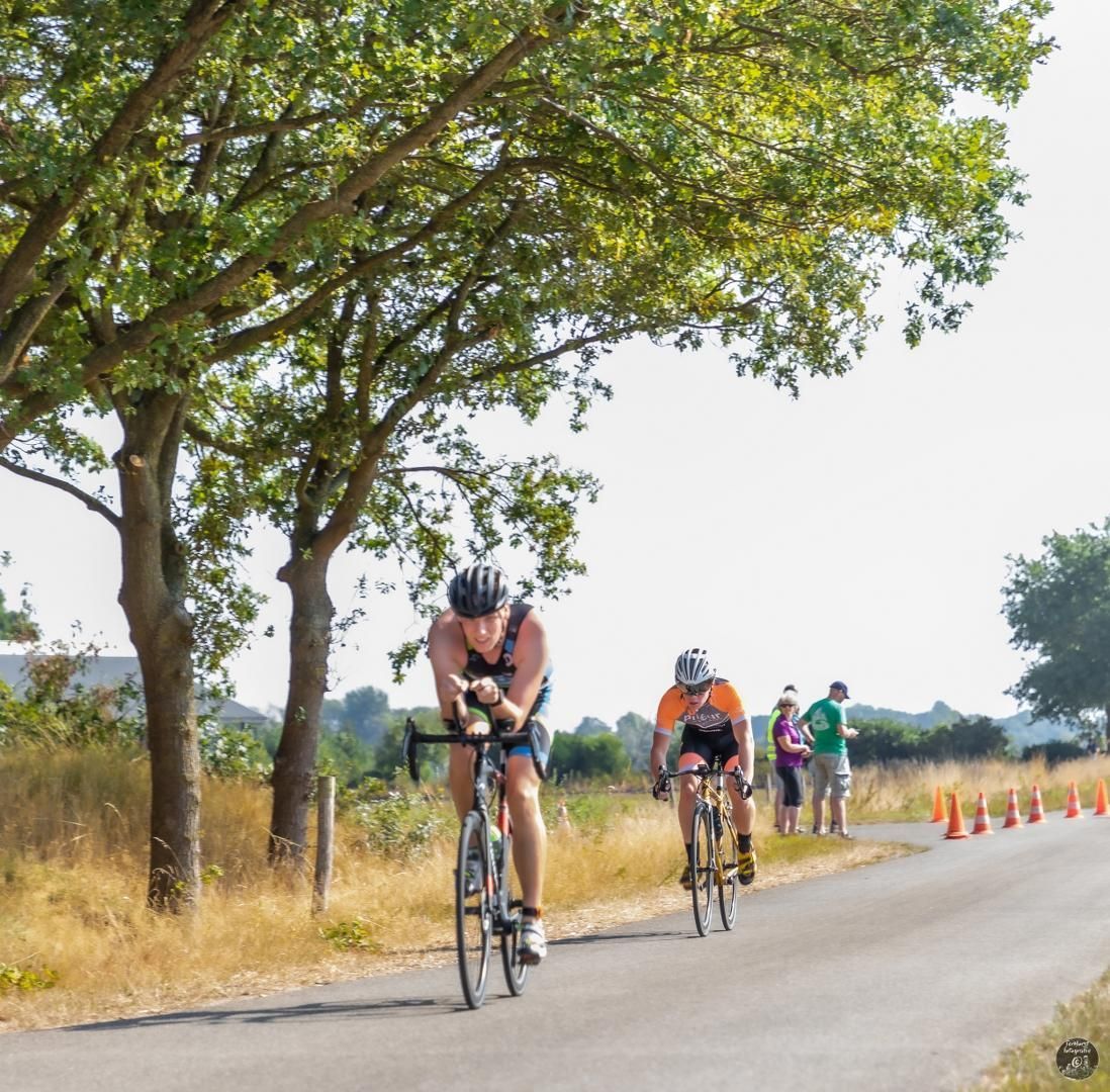 Een groep mensen fietst over een weg.