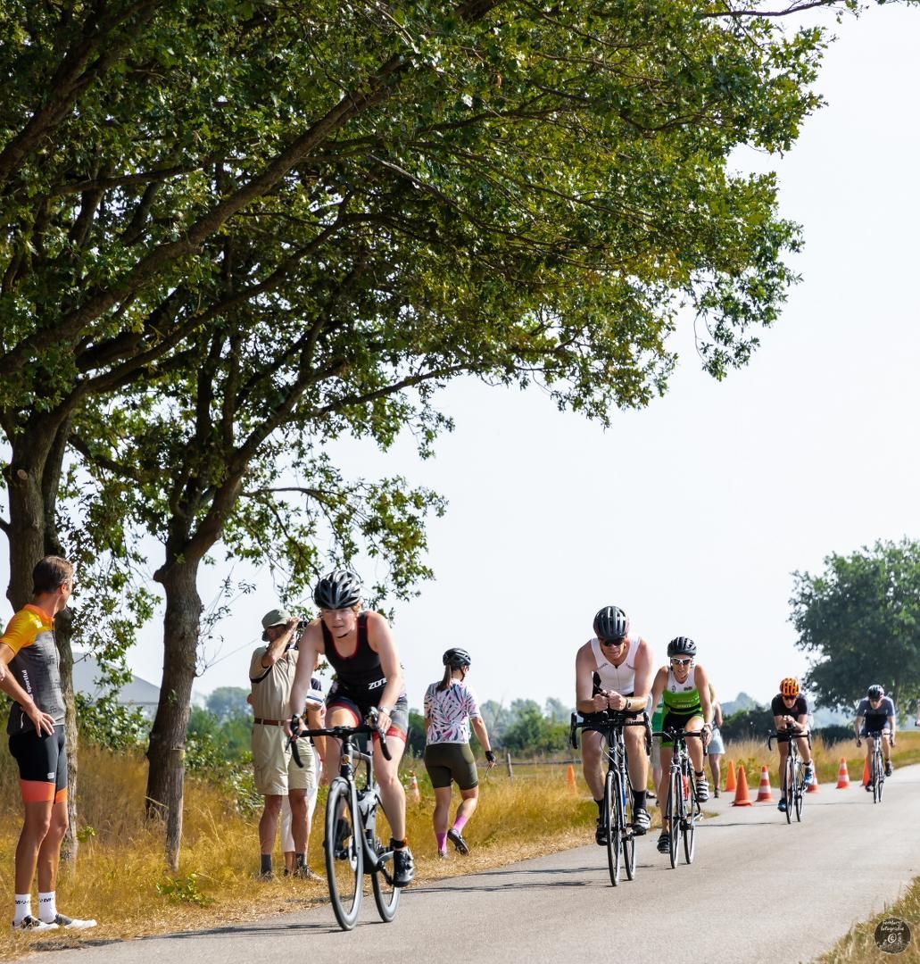Een groep mensen fietst over een weg