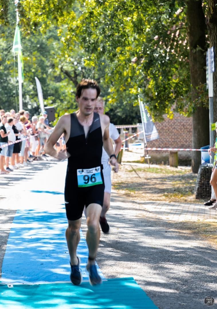 Een man doet mee aan een race met nummer 96 op zijn shirt.