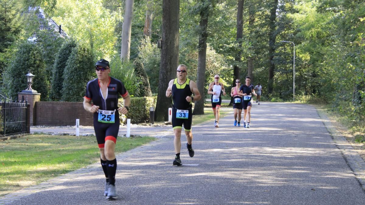 Een groep mensen rent over de weg.